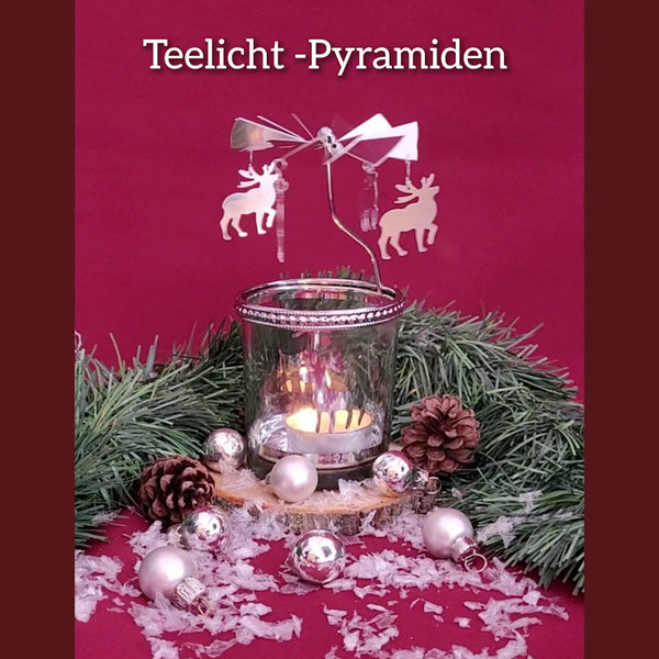 Weihnachtspyramiden mit Teelicht finden zum Beispiel diese aus Metall mit Elchen an den Flügeln im WeihnachtsDekoLand